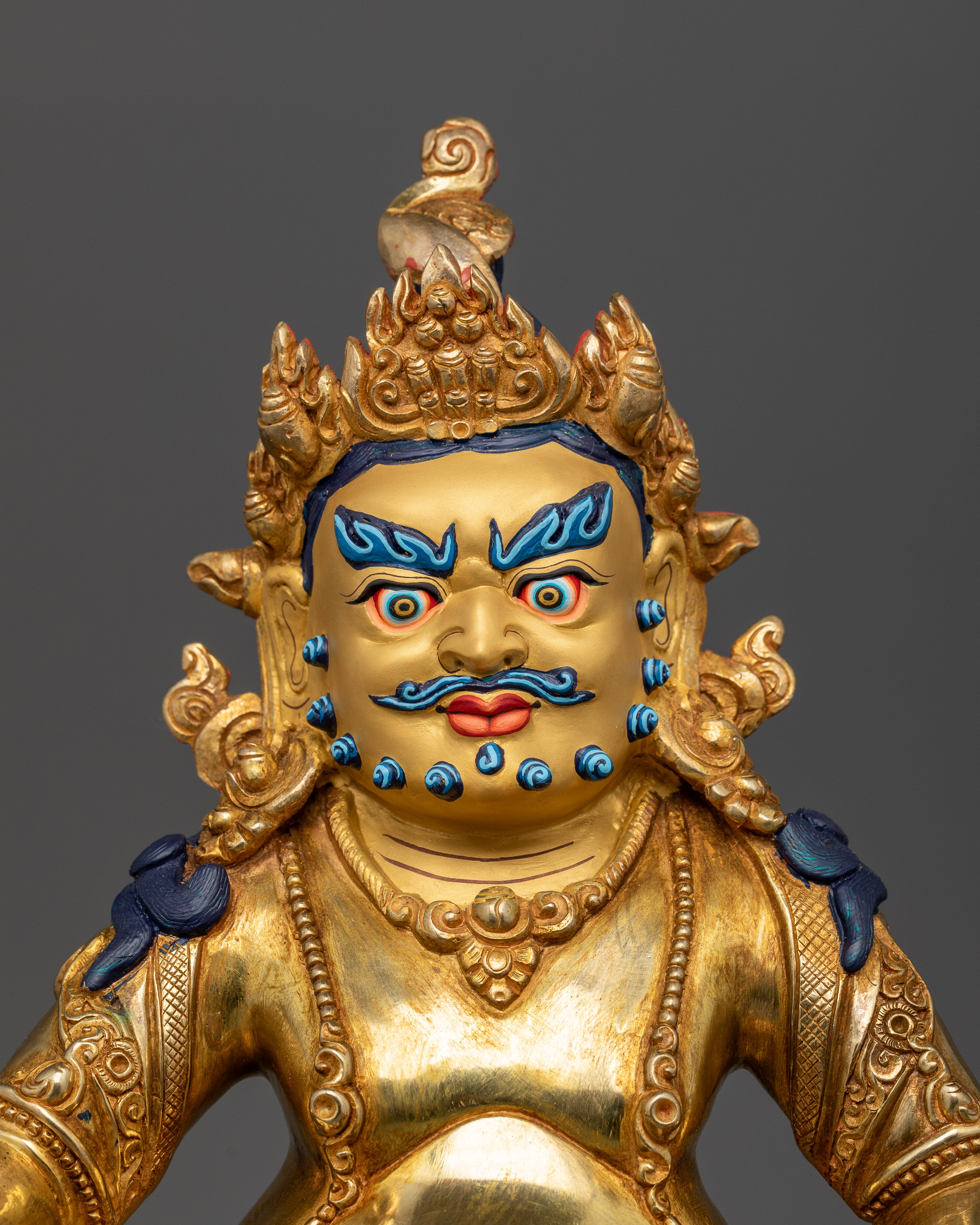 Dzambhala statue with 24K gold painted face and five jeweled crown.
