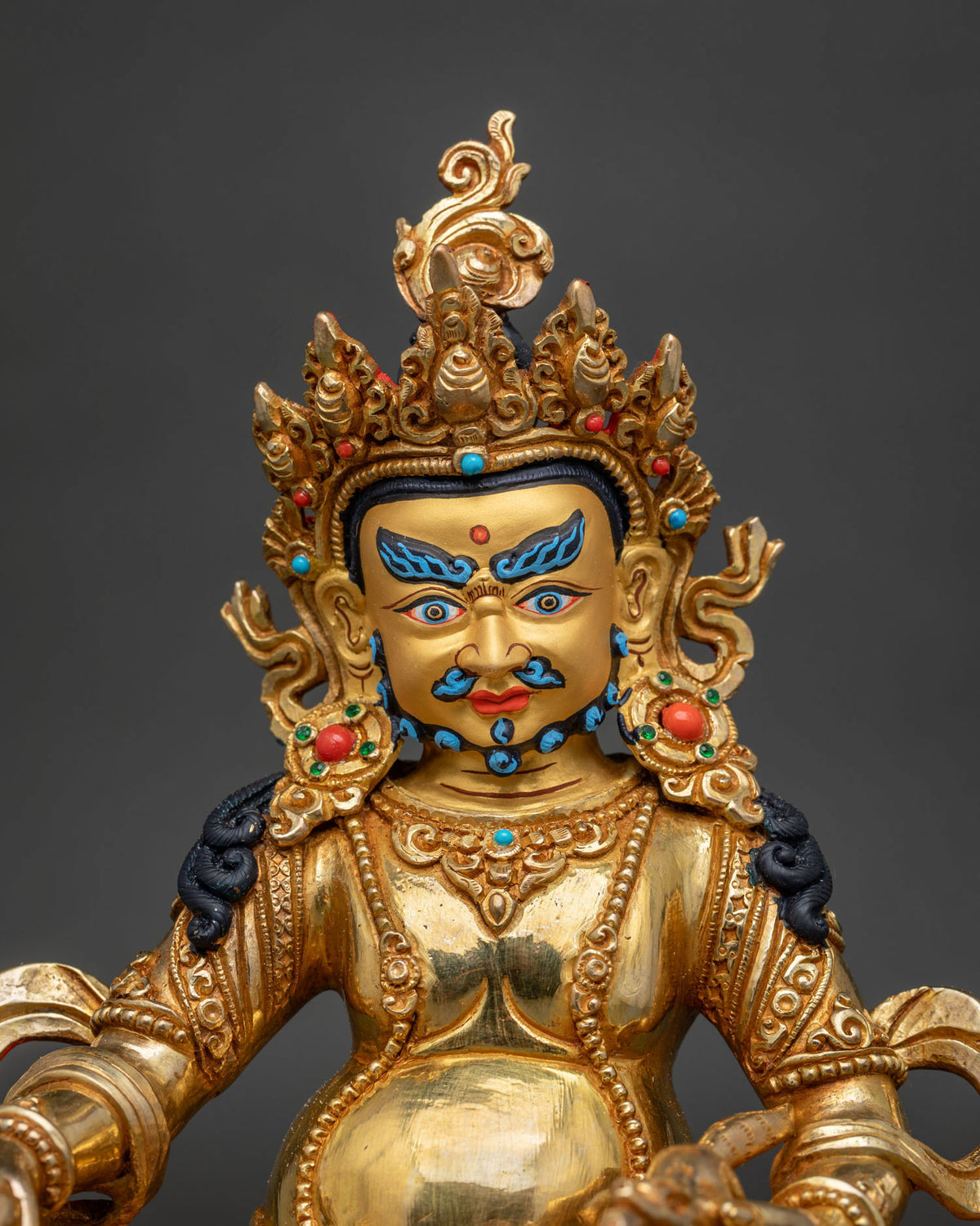 Dzambhala statue with gold fire gilded finish 24k gold painted details and semi precious stones.
