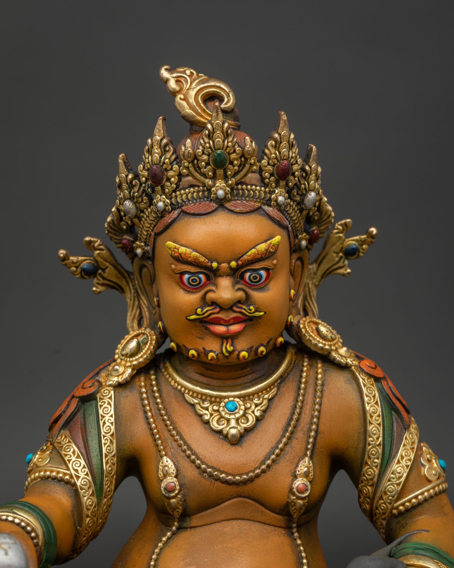 dzambhala wealth deity close up hand painted acrylic gold gilded copper sculpture nepal
