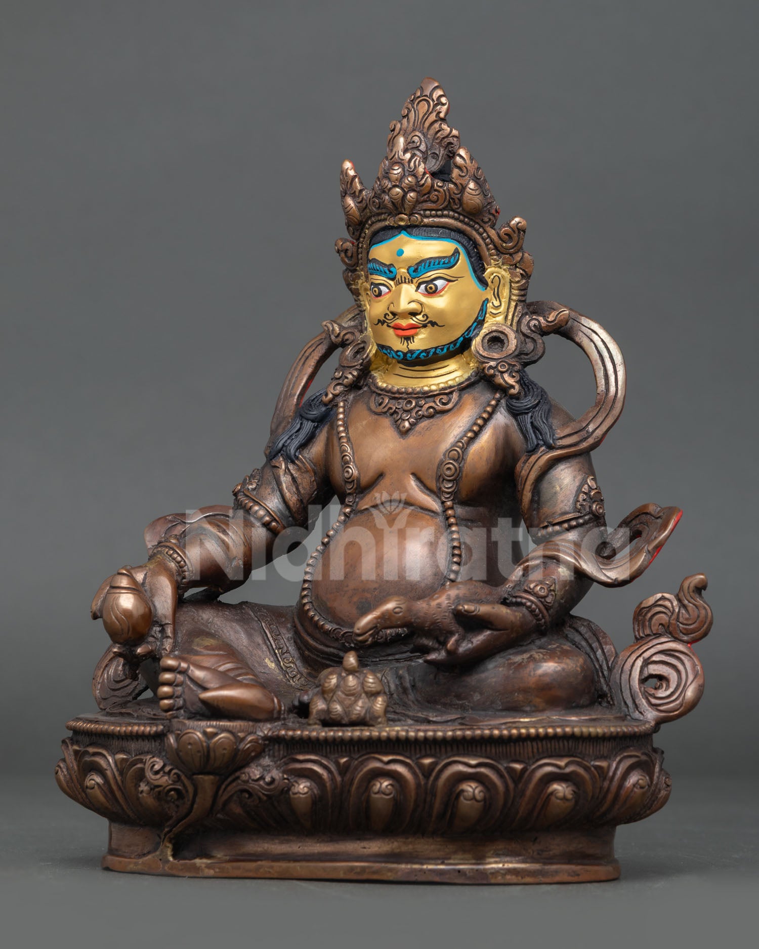 Dzambhala wealth deity holding a citron fruit and a mongoose releasing precious jewels.