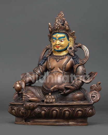 Dzambhala wealth deity holding a citron fruit and a mongoose releasing precious jewels.