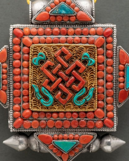Endless Knot Ghau Mala from Nepal with coral and turquoise stone inlays.