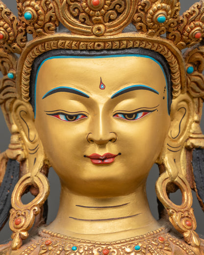 face close up of maitreya buddha statue, serene expression, gold painted face