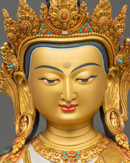 Face close up of Chenrezig Avalokiteshvara statue with serene expression and gold painted features
