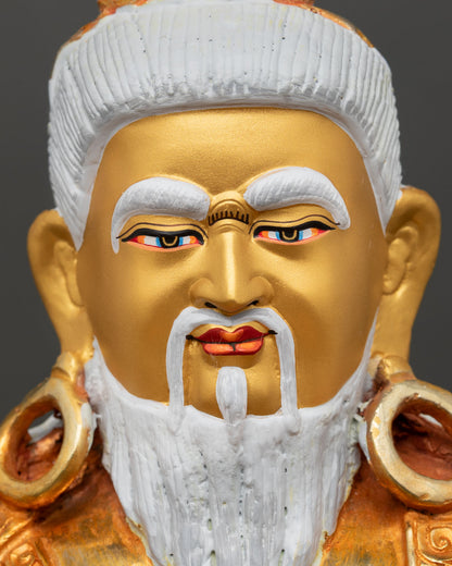 Face close up Thangtong Gyalpo statue, gold painted serene face