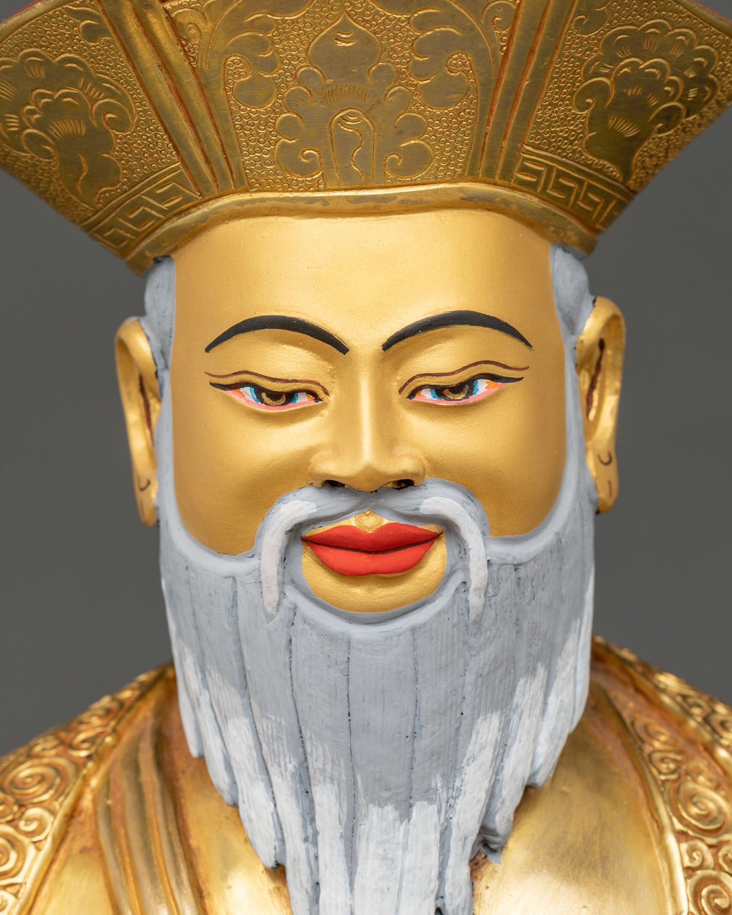 face close up zhabdrung rinpoche statue gold face white beard buddhist art