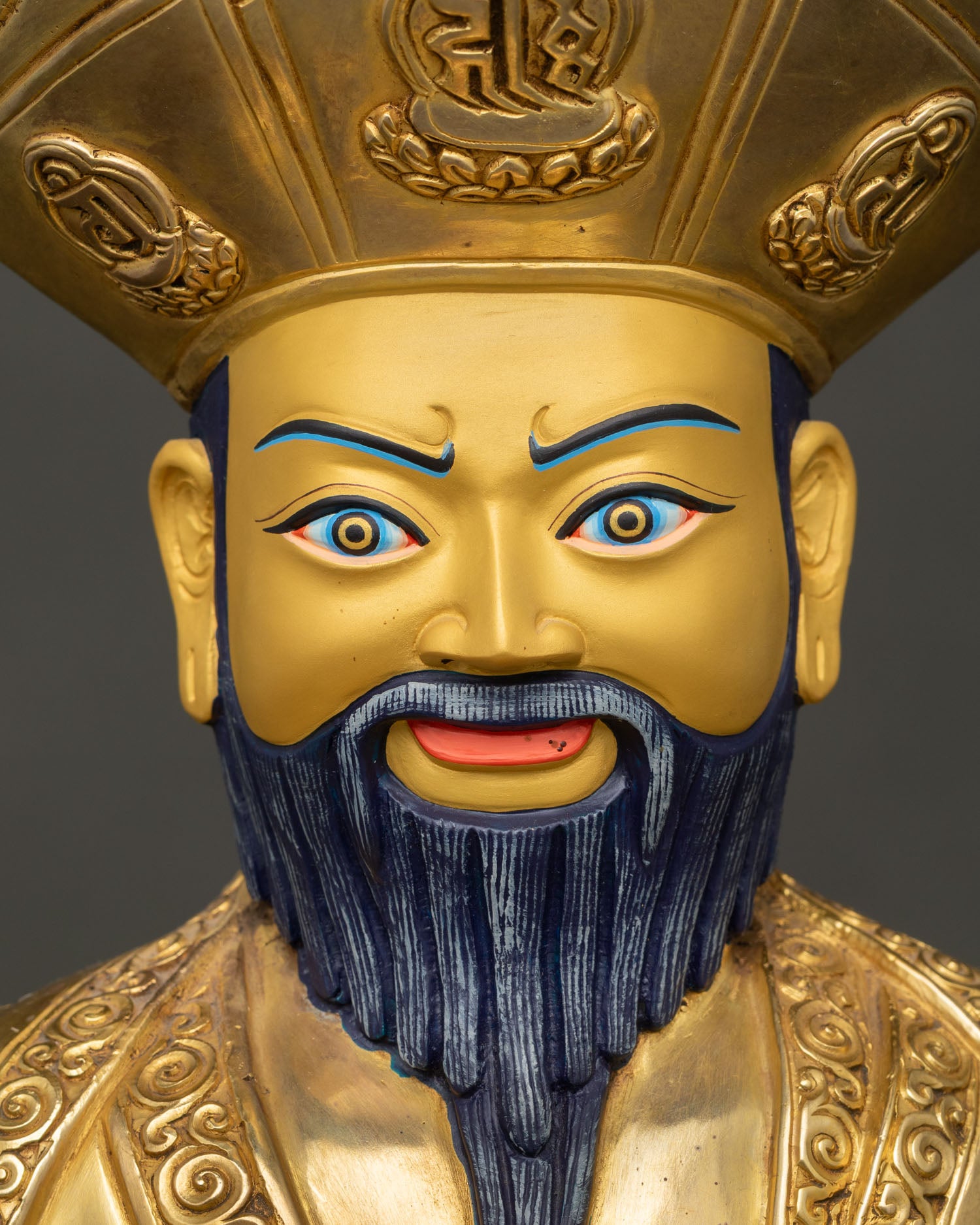 Detailed face close up of Ngawang Namgyal statue with gold painted features