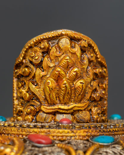 Flaming jewel Norbu finial atop Tibetan butter lamp lid symbolizing the Three Jewels Buddha Dharma Sangha