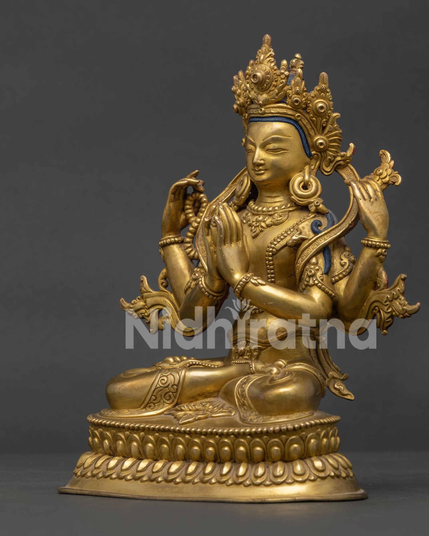 Four-Armed Chenrezig Copper Statue Holding Crystal Rosary and Lotus Flower.