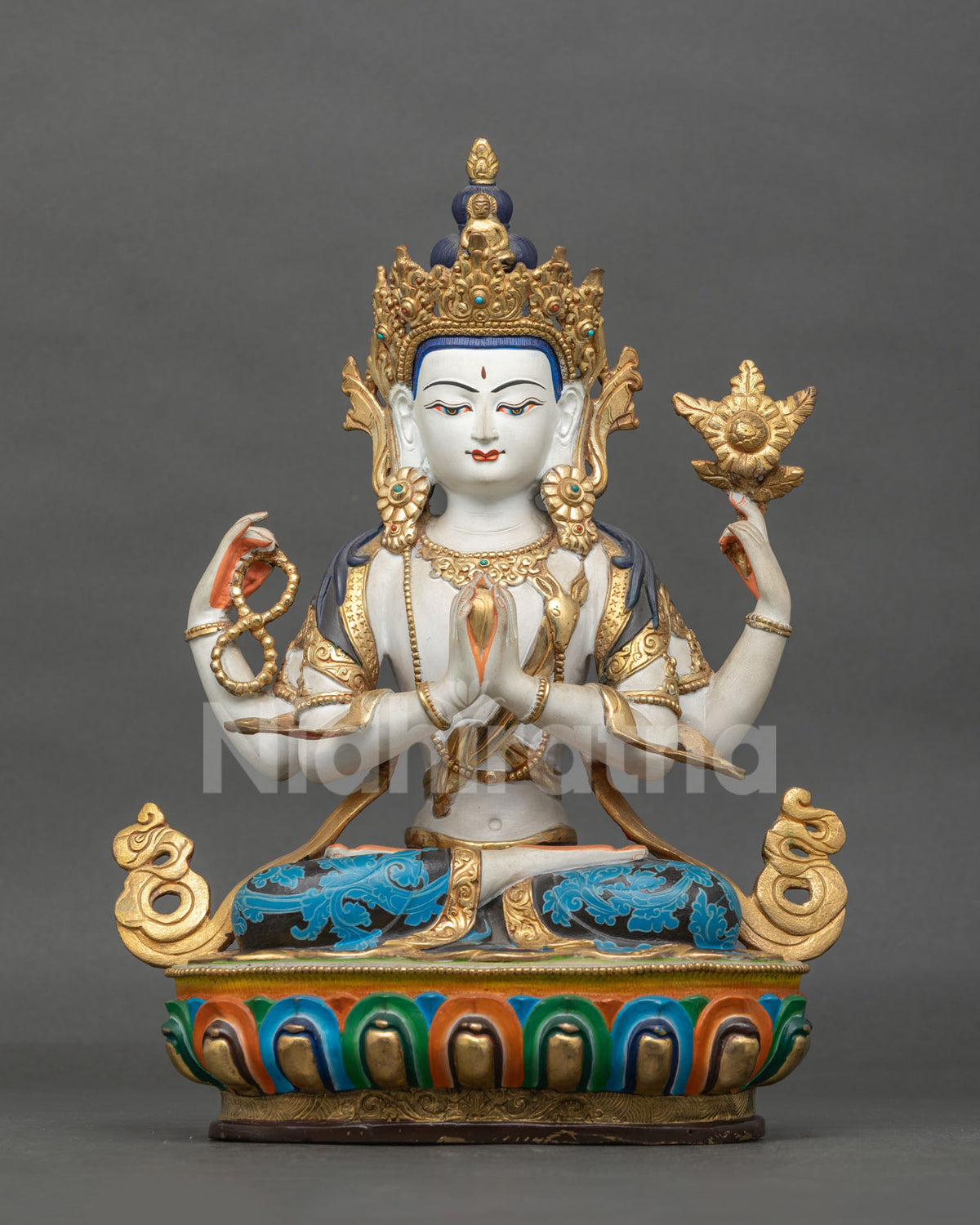 Four-armed Chenrezig statue front view showing a copper Buddhist sculpture with gold-gilded details, semi-precious stones, and a lotus pedestal.