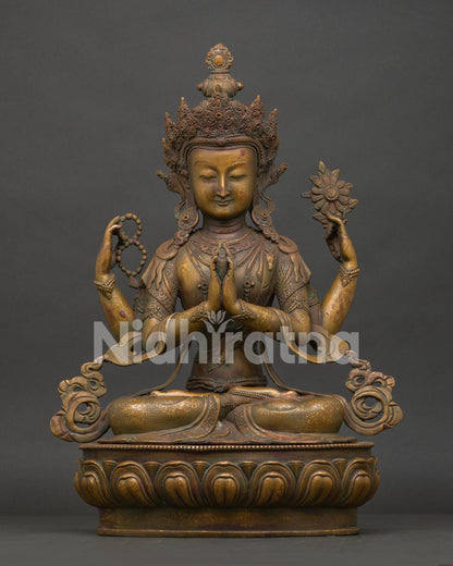 Four Armed Chenrezig statue handcrafted from oxidized copper seated on lotus pedestal in Nepal.