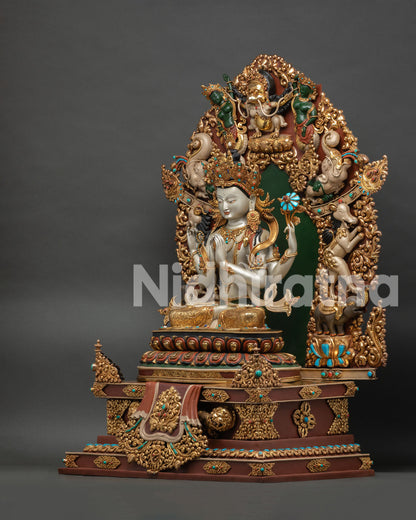 Four-Armed Chenrezig statue seated on tiered lotus throne with hand-painted aureole