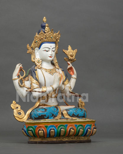Side view of four-armed Chenrezig statue highlighting intricate copper craftsmanship, semi-precious stones, and a hand-carved lotus pedestal.