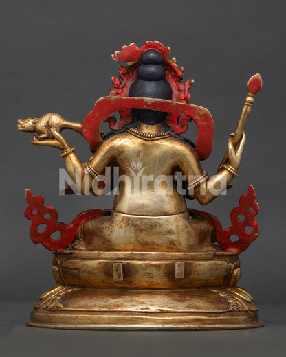 Four armed Dzambhala statue with sacred attributes handcrafted by Newari artisans.