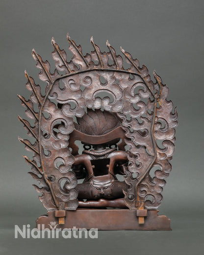 Four Armed Mahakala statue back view handmade copper sculpture from Nepal with oxidized finish detailed craftsmanship Vajrayana protector deity Buddhist altar decor.