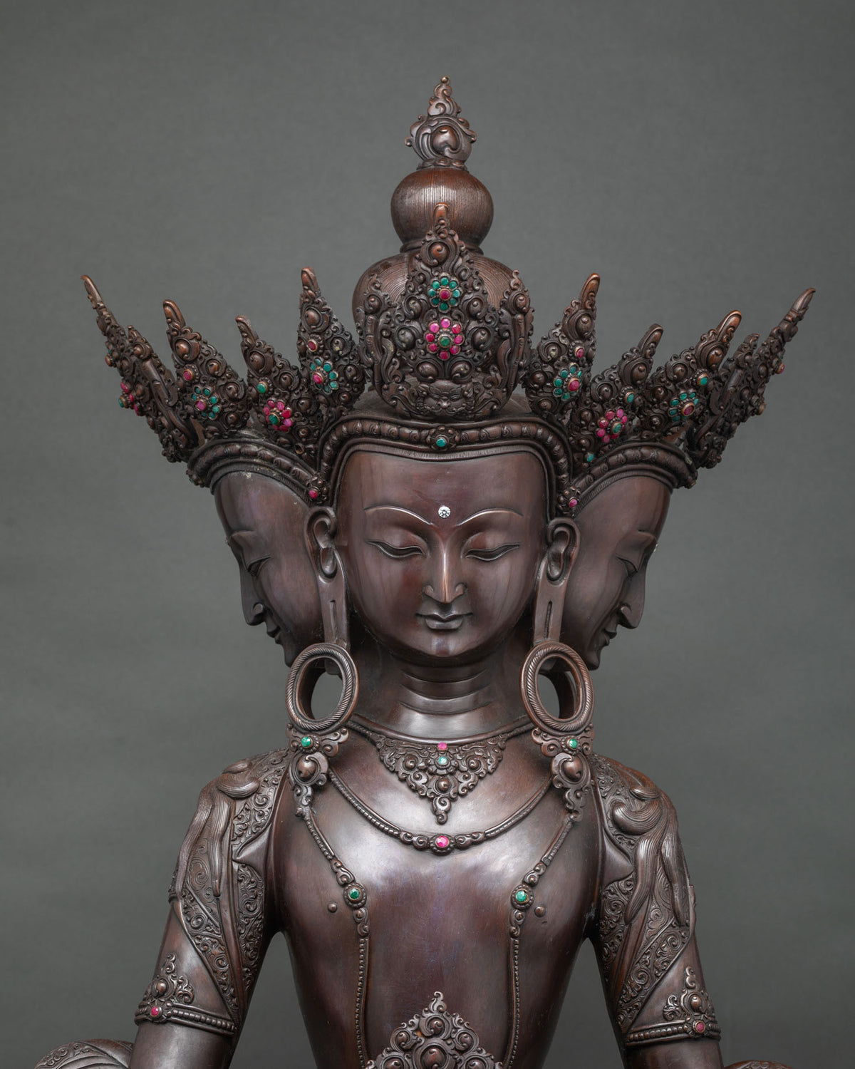 Four-headed Vairocana statue upper body with jeweled crown, earrings and necklace in oxidized copper