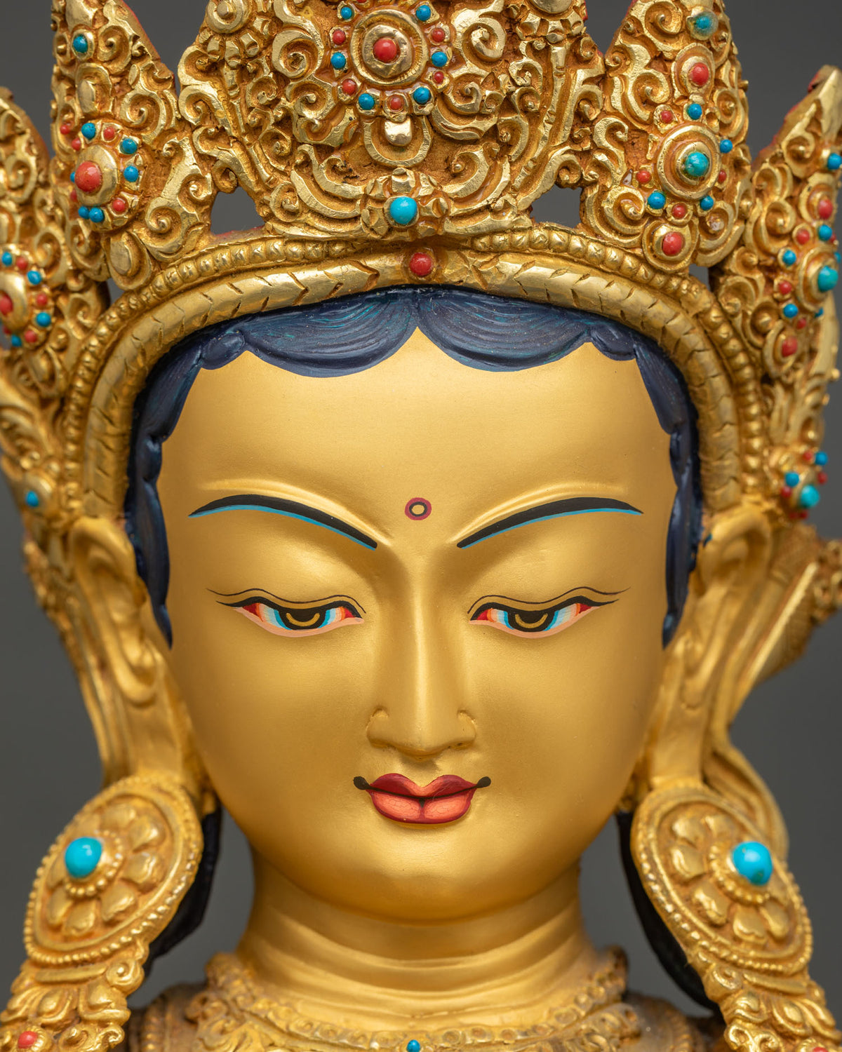 Front close-up of the serene Green Tara face and jeweled crown on a handcrafted Newari gold gilded statue