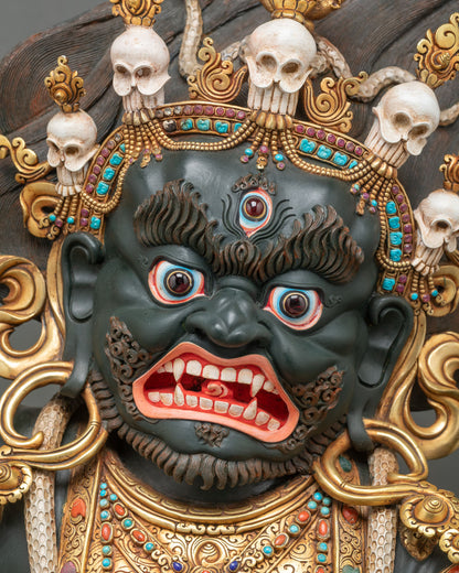 Front face of Mahakala Bernagchen with third eye, bared fangs and turquoise-set five-skull crown