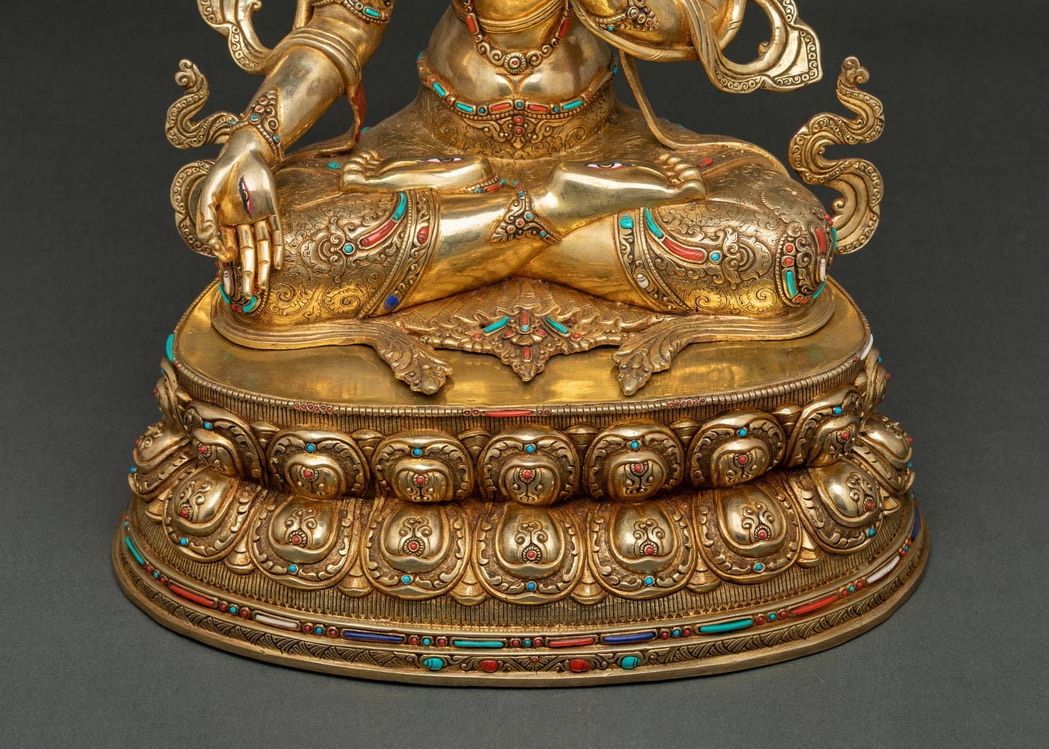 Front lotus pedestal detail with hand-chased floral engravings and stone inlays
