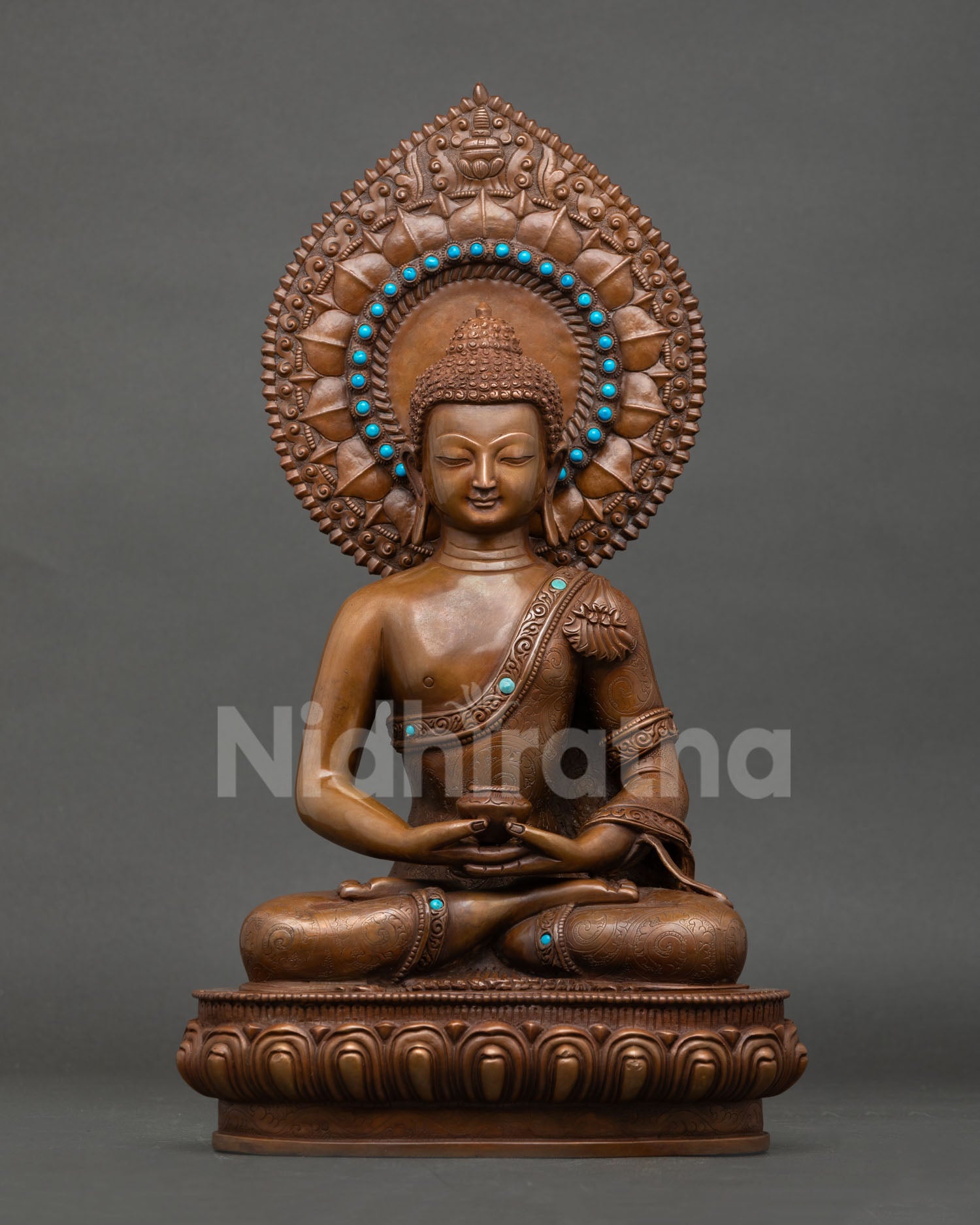Front view of Amitabha Buddha statue in oxidized copper seated on lotus pedestal with turquoise halo and alms bowl