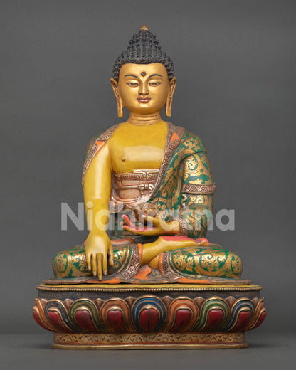 Front view of Buddha Shakyamuni statue with yellow hued body and gold painted face
