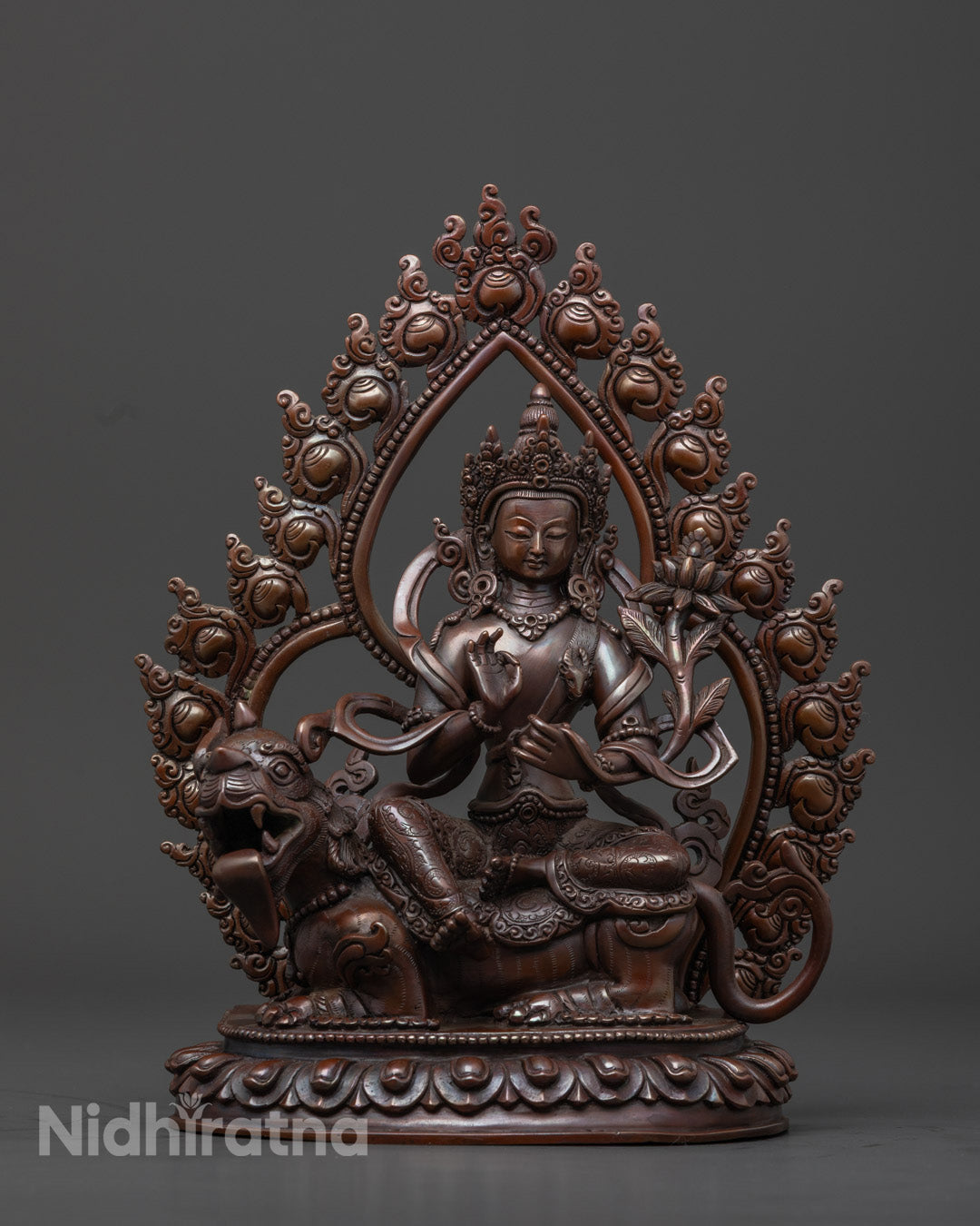 Front view of Chenrezig two-armed statue, copper oxidized finish, snow lion throne, jeweled crown