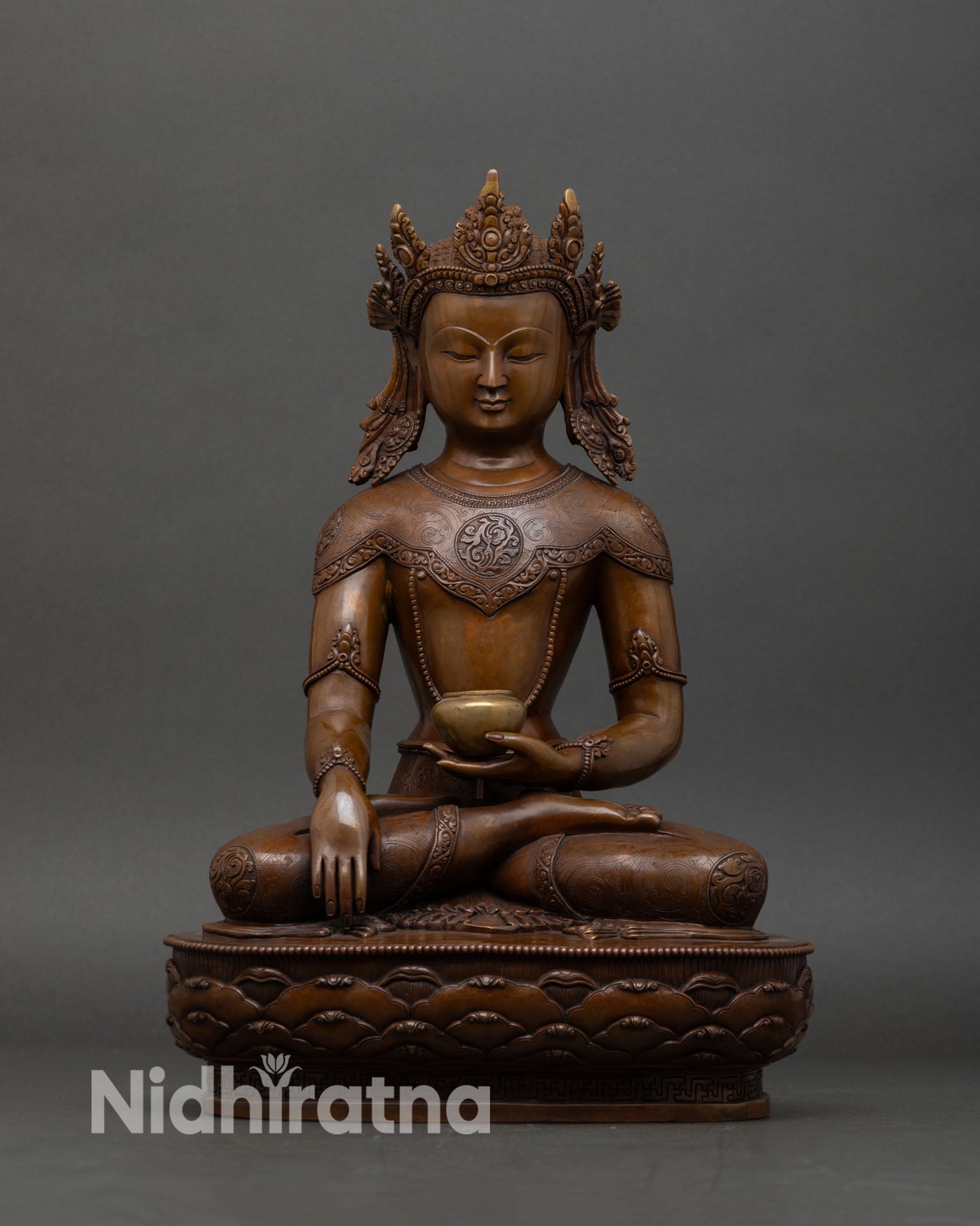 Front view of Crown Shakyamuni Buddha statue with oxidized copper finish and lotus base