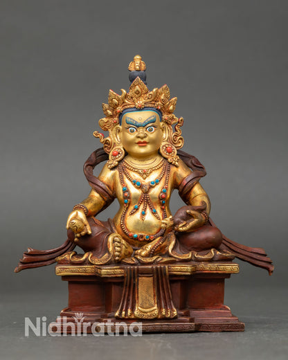 Front view of Dzambhala statue, Buddhist wealth deity, handmade copper sculpture from Nepal gold gilded oxidized finish, semi precious stones lost wax casting