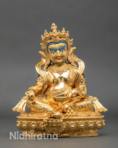 Front view Dzambhala statue gold gilded copper lotus pedestal Patan Nepal