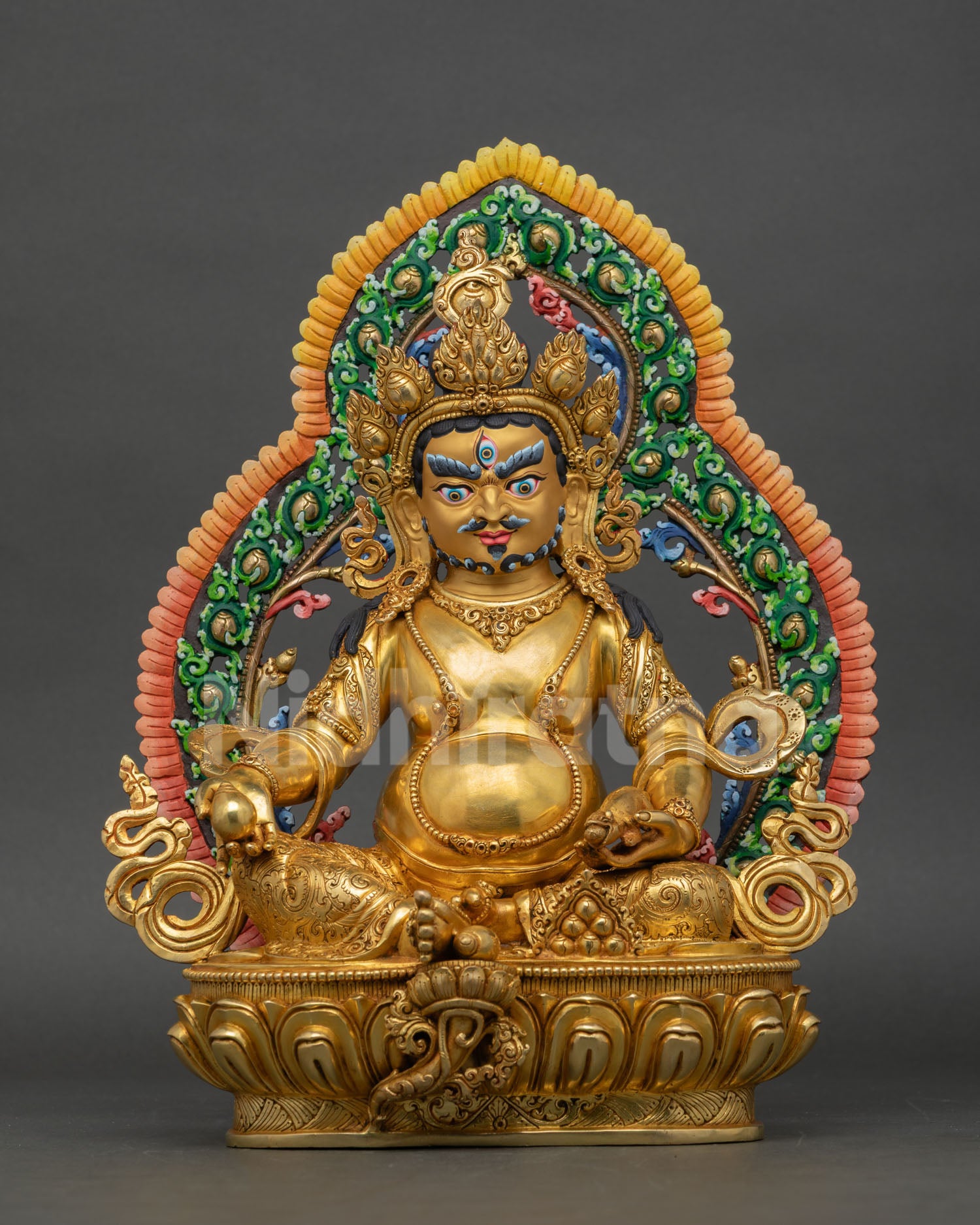 Front view of Dzambhala statue handcrafted in copper with gold gilding seated on lotus pedestal with halo for Buddhist altar