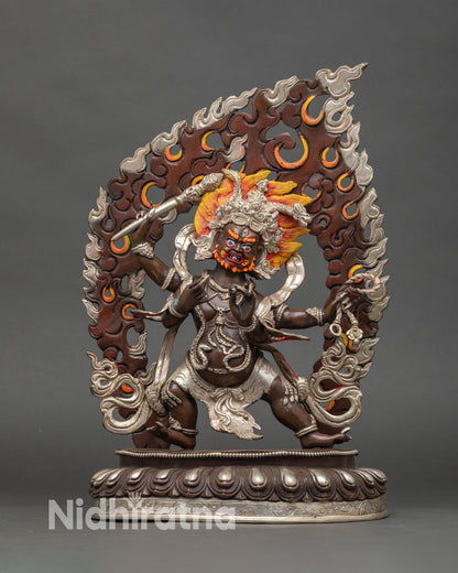 Front view of four-armed Vajrapani statue handmade copper Buddhist protector deity from Nepal oxidized silver plated finish lotus pedestal blazing halo