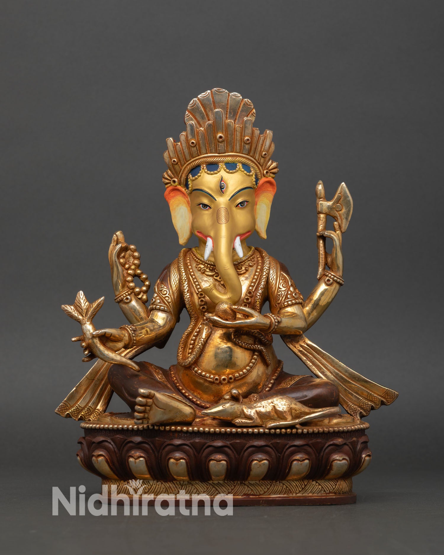 front view ganesh statue copper gold painted face elephant deity seated lotus throne royal ease pose nepal sculpture