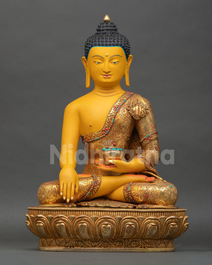 Front view of Gautama Shakyamuni Buddha statue in copper with gold gilded finish and semi precious stones for Buddhist altar decor