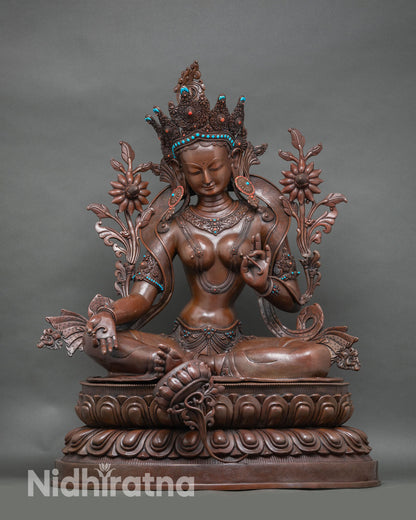 Front view of grand Green Tara statue, oxidized copper with turquoise and coral accents