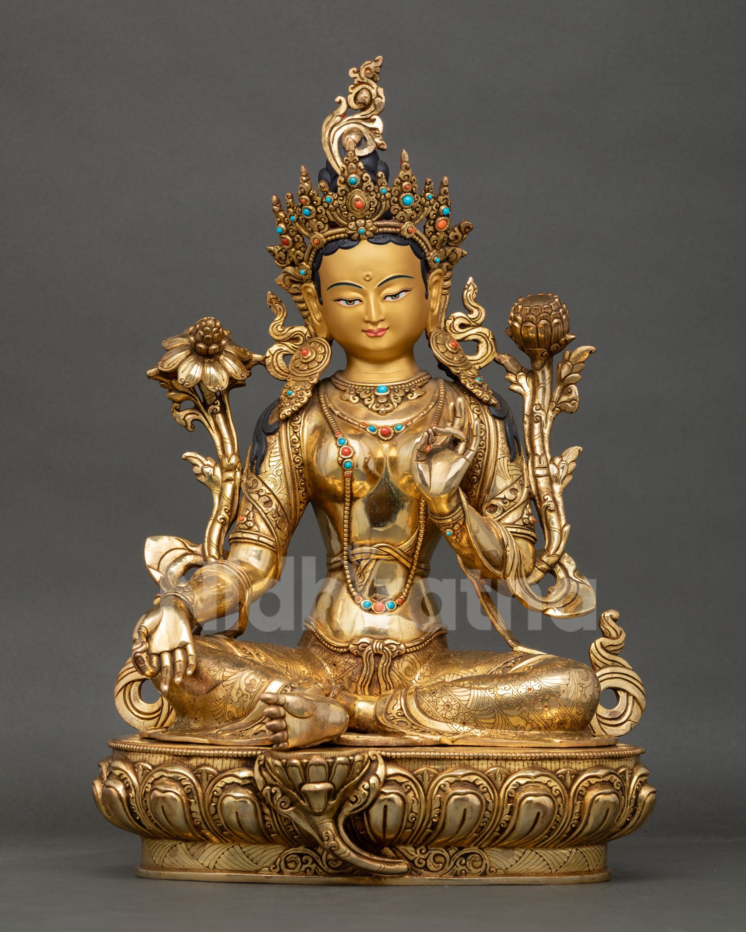 Front view of Green Tara statue, handcrafted in Nepal with gold gilded copper semi precious stones seated on lotus pedestal in lalitasana posture