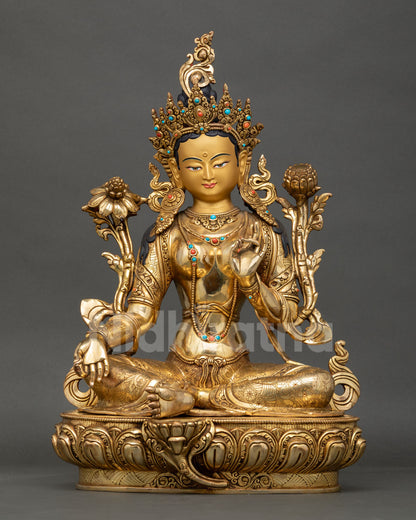 Front view of Green Tara statue, handcrafted in Nepal with gold gilded copper semi precious stones seated on lotus pedestal in lalitasana posture