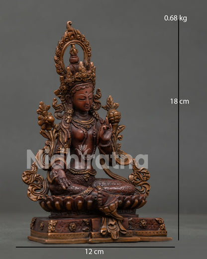 Front view Green Tara statue seated on lotus pedestal with right leg extended.