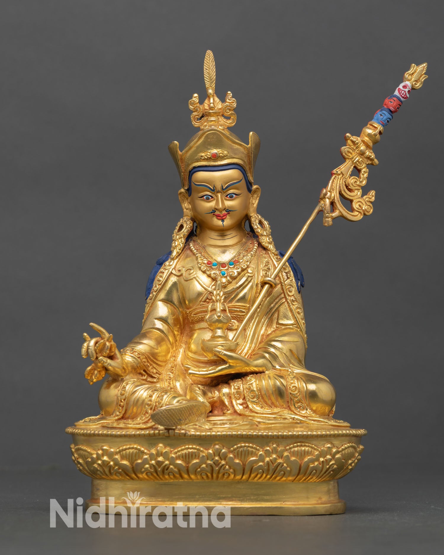 Front view of Guru Rinpoche statue copper gold gilded turquoise coral inlay seated lotus posture khatvanga staff Nepal artisan sculpture