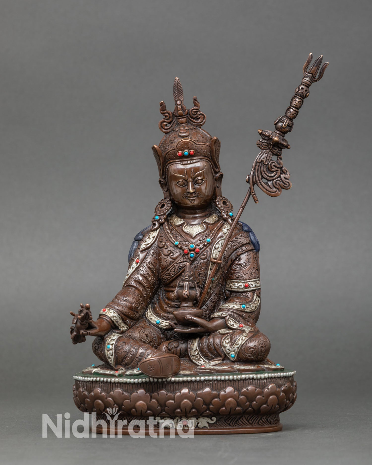 Front view of Guru Rinpoche statue handcrafted by Newari artisan from Patan Nepal oxidized copper Buddhist sculpture with silver plated details