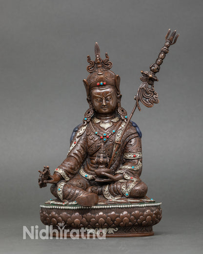Front view of Guru Rinpoche statue handcrafted by Newari artisan from Patan Nepal oxidized copper Buddhist sculpture with silver plated details