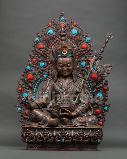 Front view of Guru Rinpoche statue with oxidized finish lotus throne and ornate halo from Nepal