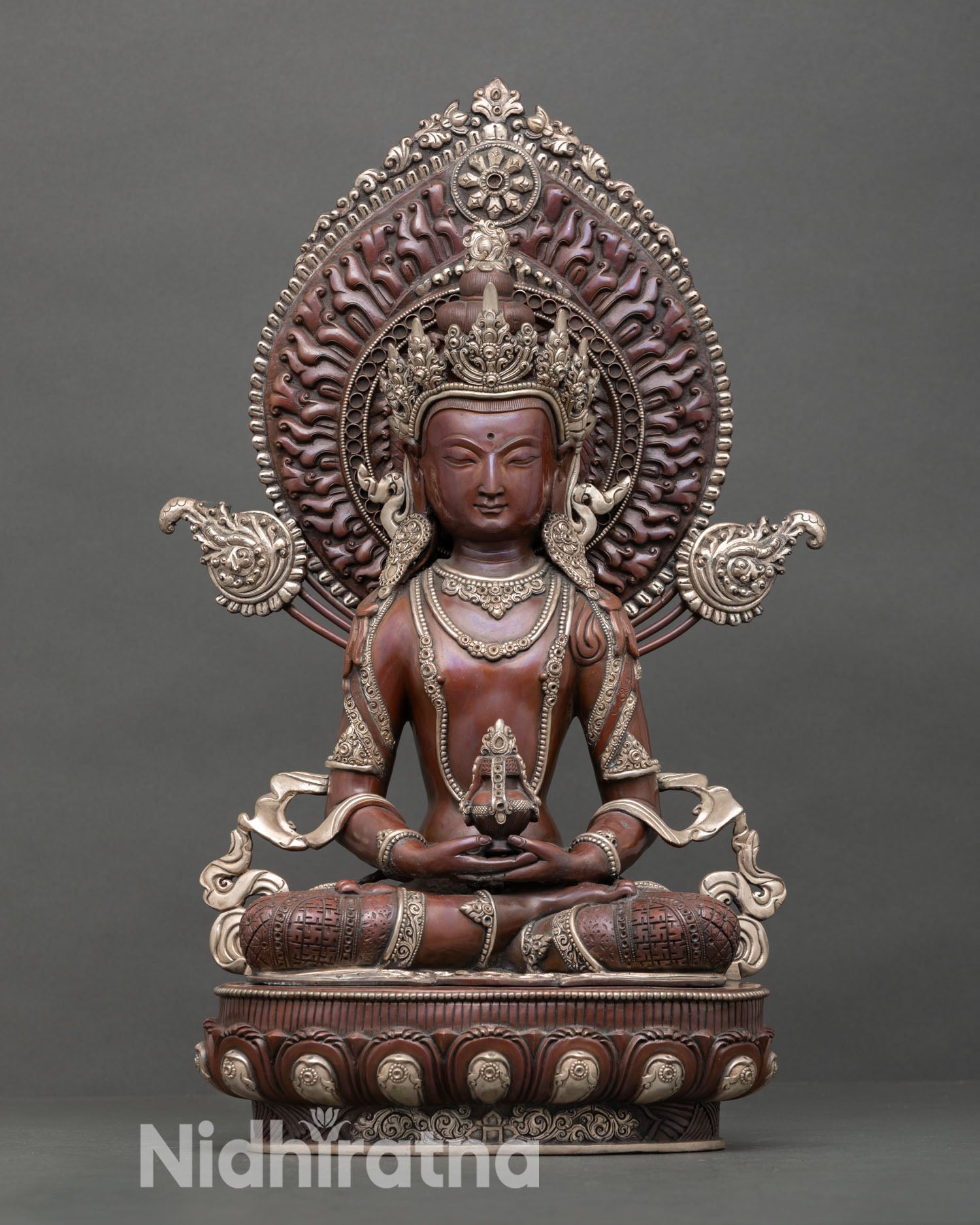 Front view of handcrafted Amitayus statue with silver plated finish and radiant halo from Nepal