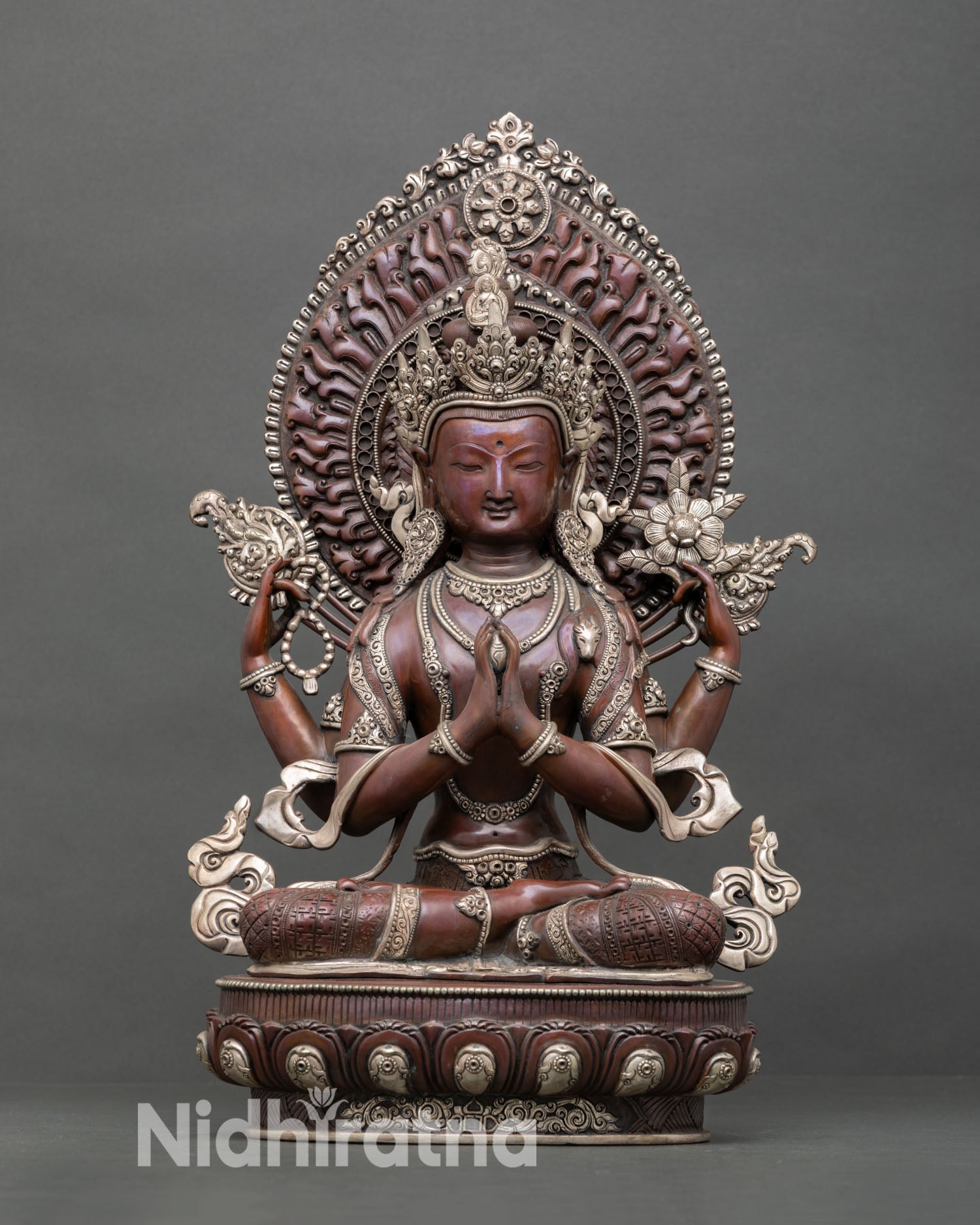 Front view of handcrafted Chenrezig statue with oxidized silver plated copper and radiant halo