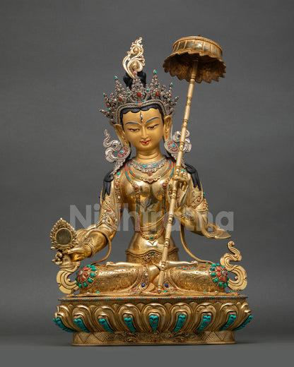 Front view of handcrafted Dukar statue made of copper with gold and silver plated details, holding sacred mirror and protective parasol Nepal