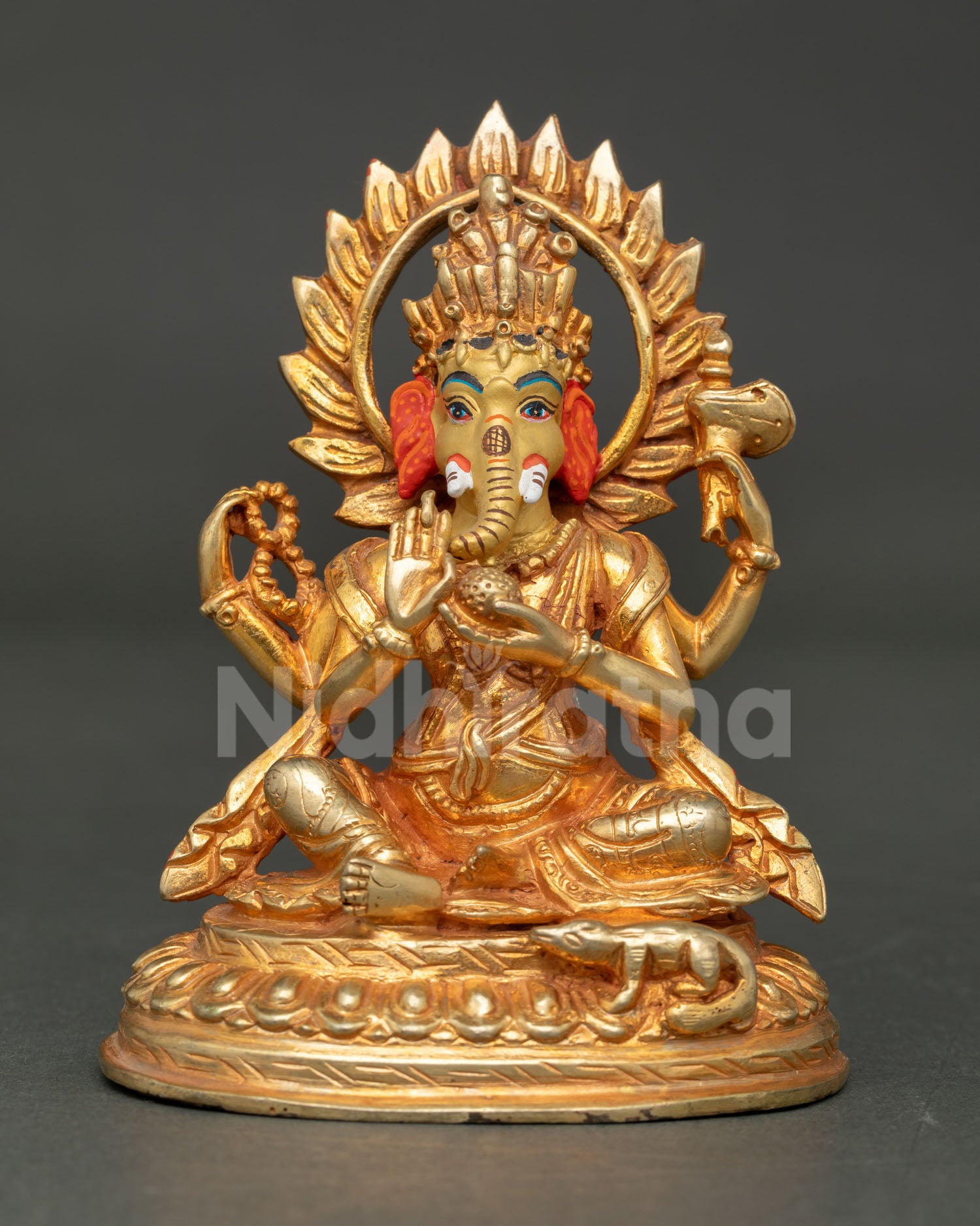 Front view of handcrafted Lord Ganesha statue with gold gilding and halo from Nepal