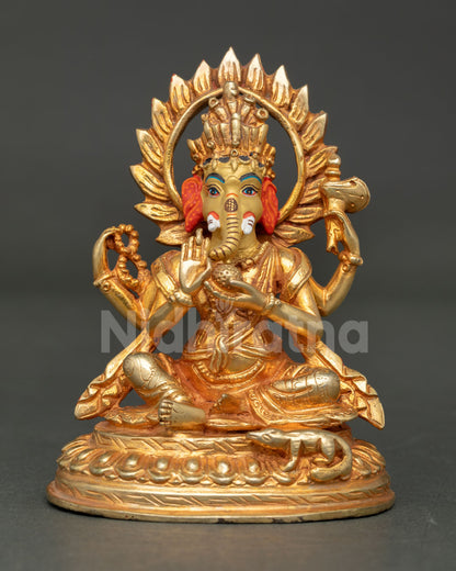 Front view of handcrafted Lord Ganesha statue with gold gilding and halo from Nepal