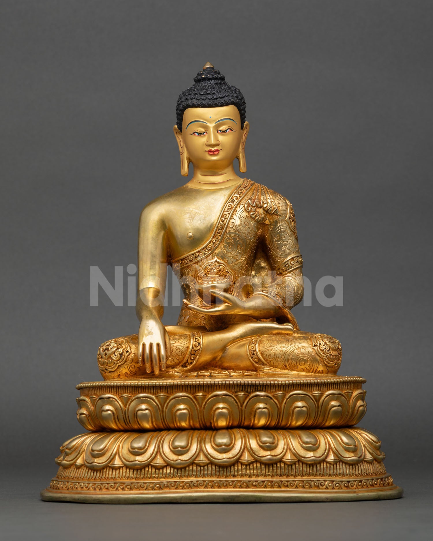 Front view of handcrafted Shakyamuni Buddha statue made of copper with gold gilding, made in Nepal