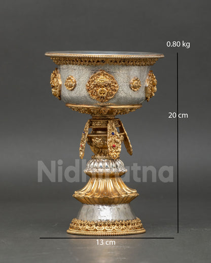 Front view of Himalayan butter lamp handcrafted in copper alloy with gold and silver plated finish featuring auspicious Buddhist symbols