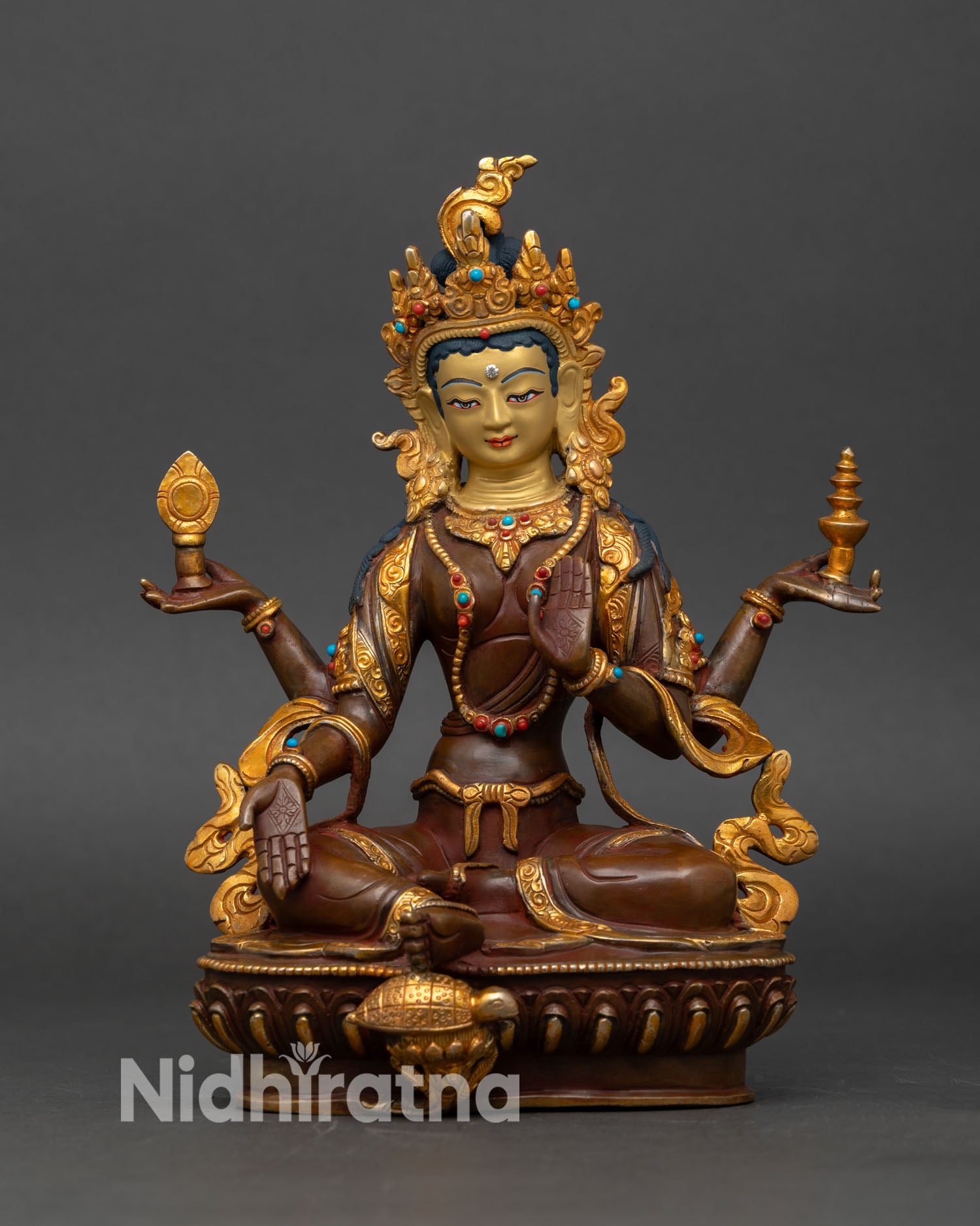 Front view of Laxmi statue handmade Nepalese copper goddess of wealth seated on lotus throne with gold gilded detailing and semi precious stones