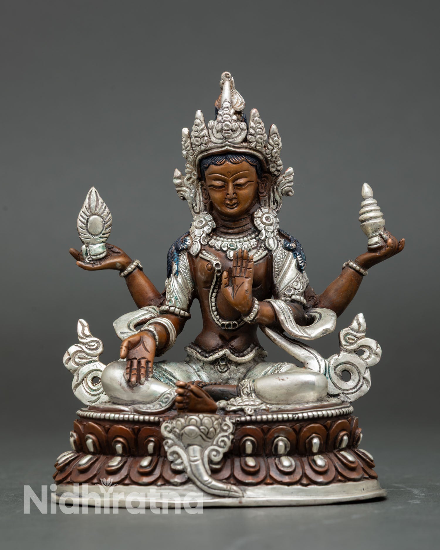Front view of Laxmi statue silver plated oxidized copper goddess of wealth seated on lotus throne Patan Nepal